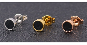 Detailed view of titanium steel stud earrings in silver, gold, and rose gold finishes