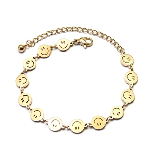 Elegant gold titanium steel bracelet with smiling face charms and adjustable lobster clasp