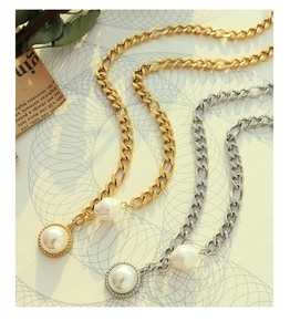 Detailed view of vintage chunky chain necklaces with freshwater pearls in gold and silver