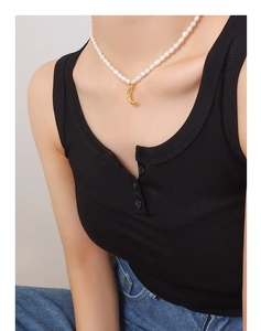 Close-up of natural freshwater pearl necklace with textured gold crescent moon pendant