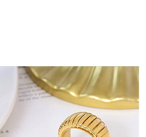 Macro shot of gold-plated ribbed C-shape vintage ring with elegant texture detail