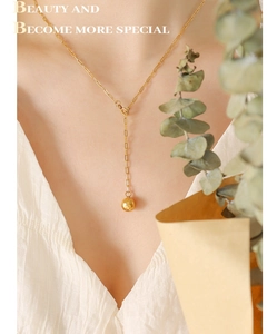Detailed view of adjustable Y-shaped 18K gold-plated titanium necklace with ball pendant