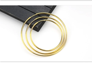 Detailed set of three polished gold hoop earrings in small, medium, and large sizes