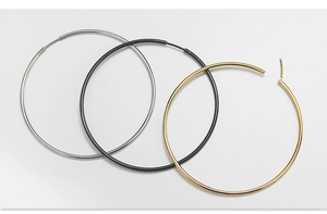 Three-piece set of large round hoop earrings in gold, silver, and black polished metal
