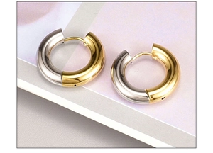 Detail of two-tone gold and silver circular hoop earrings with secure snap closure