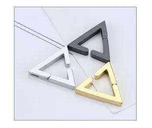 Macro detail of geometric U-shaped clip earrings in silver, black and gold finishes