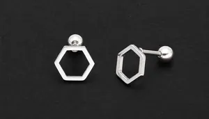 Detailed macro view of geometric hexagonal stainless steel studs with ball back closures