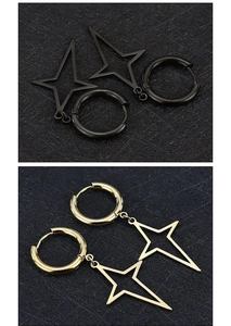 Detailed view of matte black and polished gold star pendant earrings in medical titanium steel
