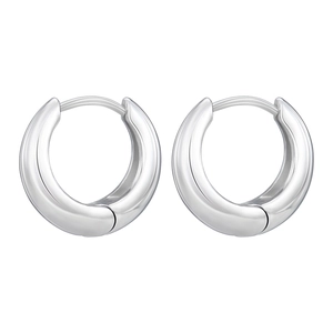 Minimalist silver huggie hoop earrings with a polished mirror finish on white background