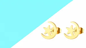 Detail view of gold-tone star and crescent moon stud earrings with hollow design