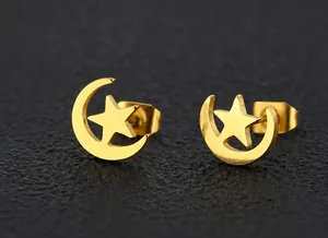 Close-up of gold-plated celestial stud earrings with star and crescent moon design