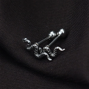 Detailed macro view of silver snake-shaped titanium steel studs with textured scales