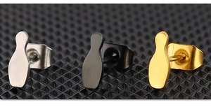 Macro detail of bowling pin stud earrings in silver, black and gold plated stainless steel