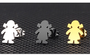 Macro detail of minimalist girl silhouette stud earrings in silver, black and gold finishes