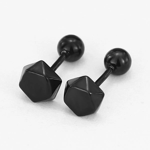 Detailed macro view of black geometric studs with a polished mirror finish and ball backs