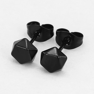 Macro shot of black geometric icosahedron earrings with matte finish and butterfly backings