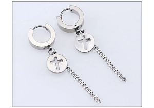 Detail of stainless steel drop earrings featuring cross cutouts and long curb chains