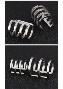 Close-up of silver multi-layer stainless steel ear cuff for non-pierced ears on black background