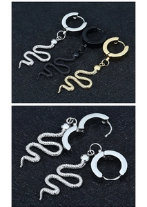 Detail view of snake dangle earrings in silver gold black finishes with scale texture