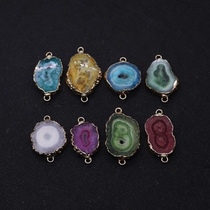 Detail view of 8 assorted natural stone crystal pendants with gold edges and double loops
