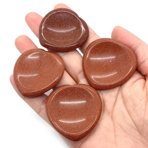 Polished heart-shaped red goldstone healing palm stones with sparkling gold flecks
