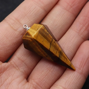 Detailed close-up of tiger eye stone conical pendant with unique brown fibrous textures