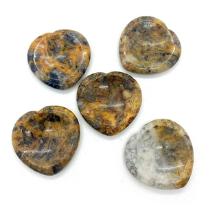 Polished heart-shaped thumb stones made of natural nine-eyed stone with unique patterns