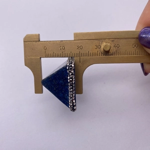 Lapis lazuli pyramid pendant thickness measurement showing 18.5mm on a brass caliper