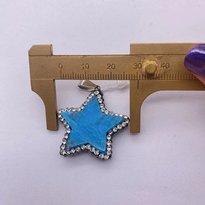 Detailed measurement of 30mm star-shaped pendant with blue stone and crystals