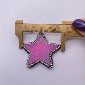 Detail view of pentagram stone pendant being measured with a caliper showing 45mm width