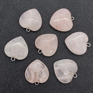 Detailed view of heart-shaped natural rose quartz pendants with silver metal bails
