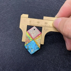 Detail view of hex shaped multi-color turquoise stone pendant with 18mm width measurement