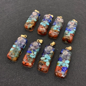 Macro detail of eight resin orgone energy pendants with crushed stones and metal wire