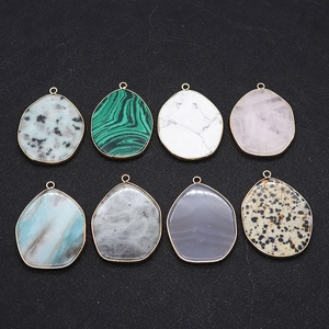 Close-up of semi-precious stone pendants with gold metal edging and unique textures
