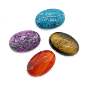 Polished oval natural gemstones including tiger eye and carnelian for jewelry making
