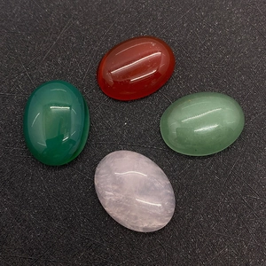Detailed view of four oval 15x20mm natural stone cabochons in red green and pink tones