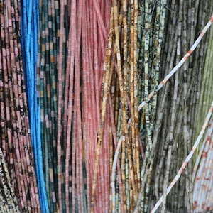 Detailed macro view of 2x4mm colorful natural emperor stone cylinder beads for DIY jewelry