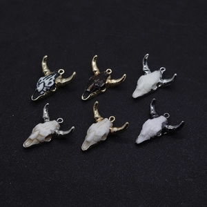 Detailed set of six resin bull skull pendants with metallic gold and silver horn accents
