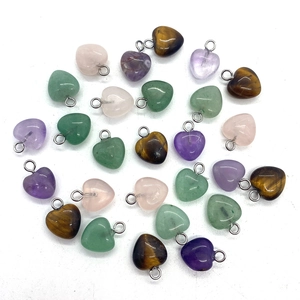 Detailed view of assorted heart-shaped natural stone pendants with silver metal connectors