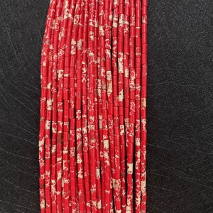 Macro detail of red imperial jasper tube beads with natural marbling for DIY jewelry