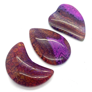 Dragon veins agate pendants in heart, drop, and moon shapes with purple red hues
