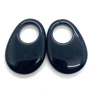 Polished black teardrop ear weights with circular cutouts for stretched lobes