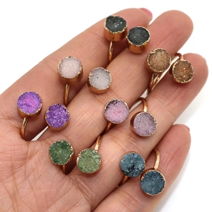 Naturstein Druzy Ringe in vielen Farben mit goldenem Band an der Hand gezeigt