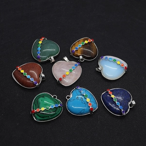 Macro detail of eight heart-shaped gemstones with rainbow seven chakra metal inlay