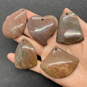 Detailed view of five natural agate stone pendants in various geometric shapes with pre-drilled holes
