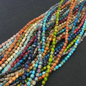 Macro detail of multi-colored Imperial Jasper beads with natural stone textures for DIY jewelry