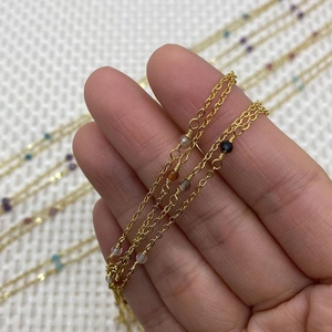 Detail showing golden copper O-chains with natural faceted stone beads for DIY jewelry