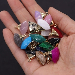 Detailed view of assorted natural stone fan-shaped pendants with gold-plated ring hooks