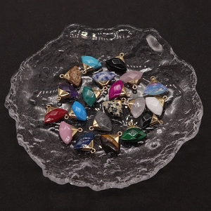 Macro view of multi-color gemstone fan-shaped pendants with golden metal loops