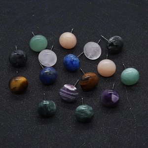Flat lay of multiple 12mm round natural gemstone stud earrings on black textured background